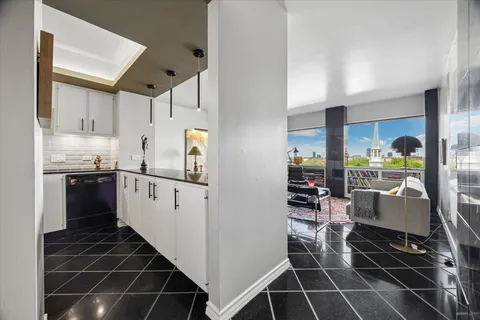a kitchen with stainless steel appliances a refrigerator sink and cabinets