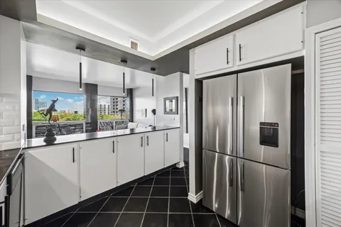 a kitchen with stainless steel appliances a refrigerator and a sink