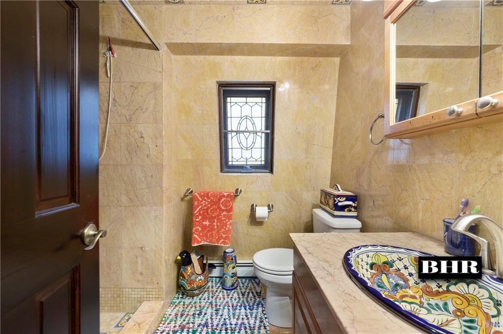 179 Norfolk Street Brooklyn, NY 11235 - Photo 19 of 31 a bathroom with a sink toilet and shower