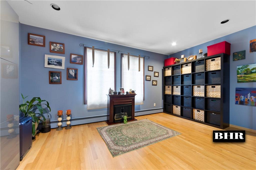 179 Norfolk Street Brooklyn, NY 11235 - Photo 20 of 31 a bedroom with a bed and a book shelf