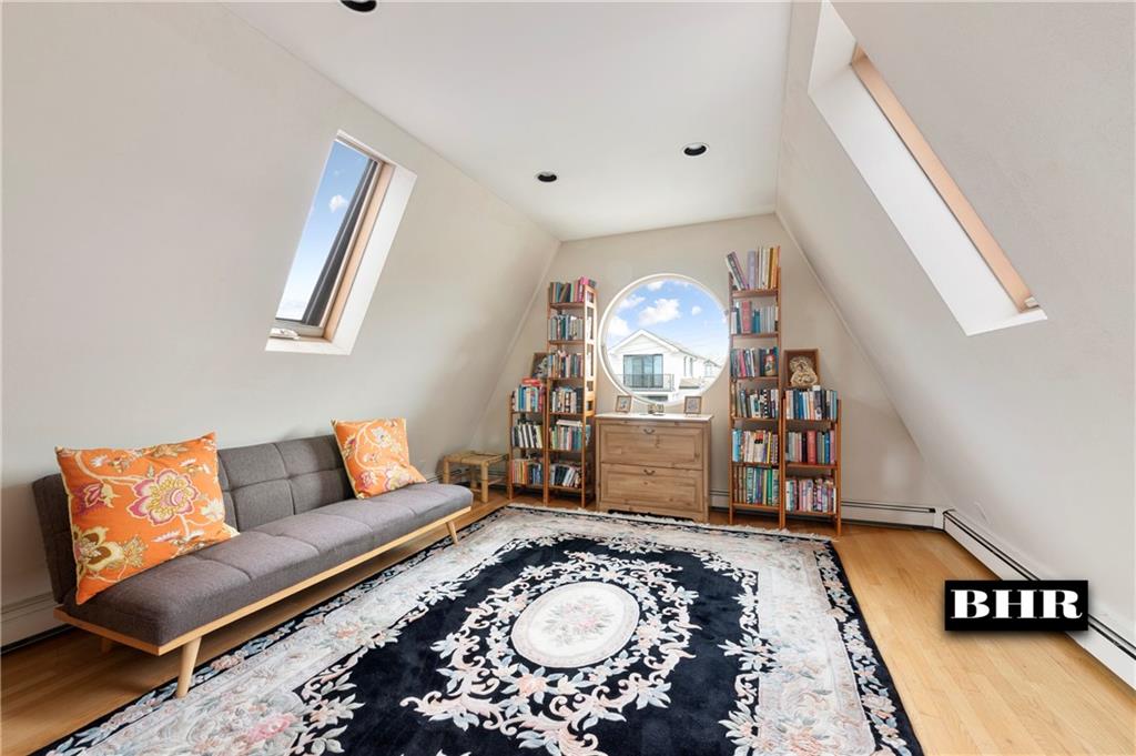 179 Norfolk Street Brooklyn, NY 11235 - Photo 23 of 31 a living room with furniture and a wooden floor