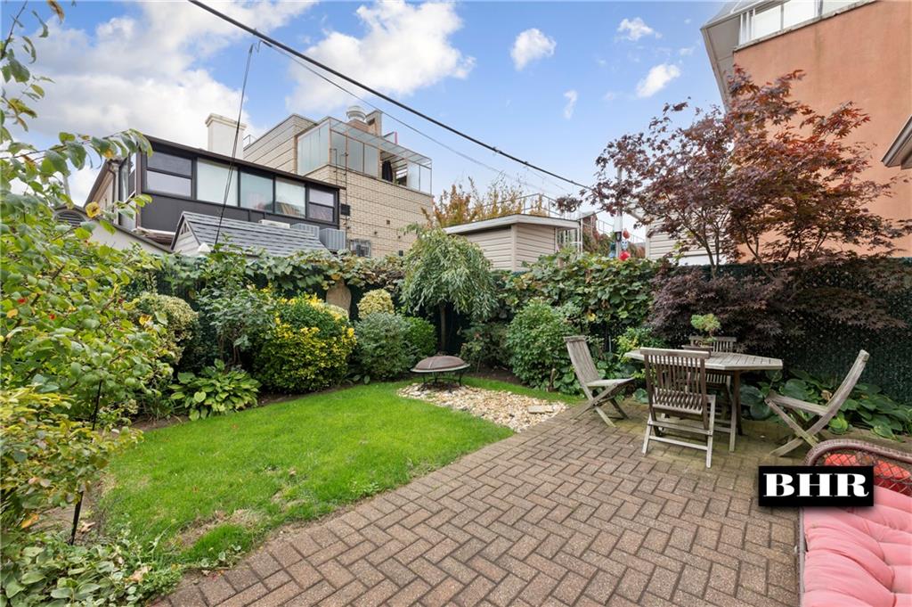 179 Norfolk Street Brooklyn, NY 11235 - Photo 28 of 31 a backyard of a house with a table and chairs