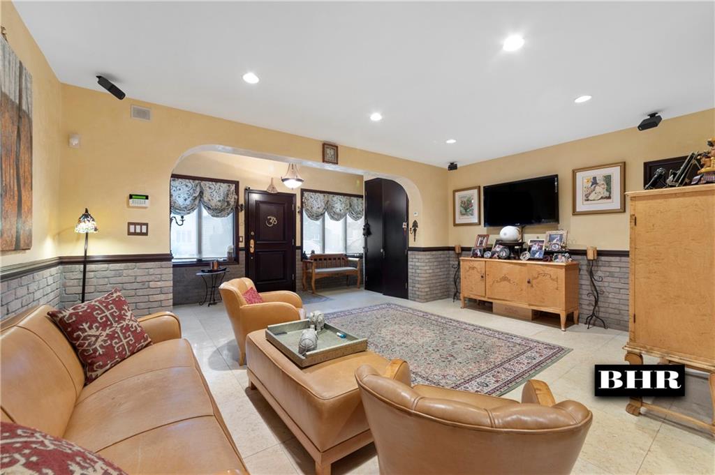 179 Norfolk Street Brooklyn, NY 11235 - Photo 3 of 31 a living room with furniture and a flat screen tv