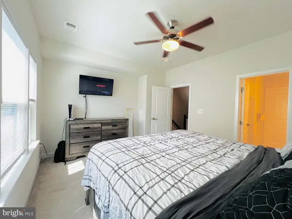 a bedroom with a bed and a ceiling fan