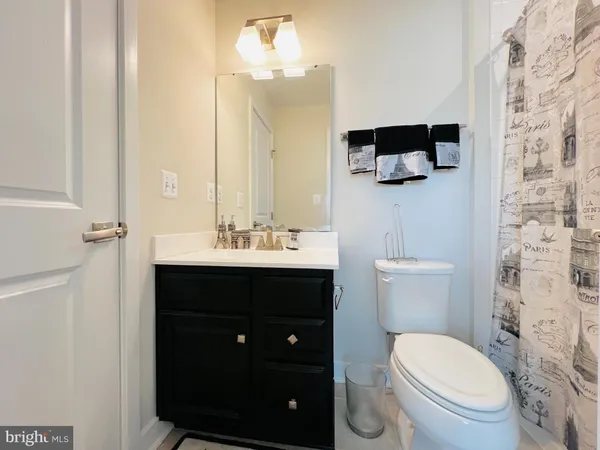 a white toilet sitting next to a bath tub