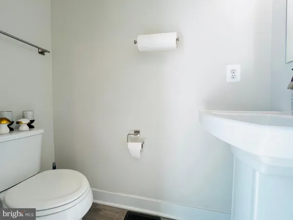a white toilet sitting next to a white sink