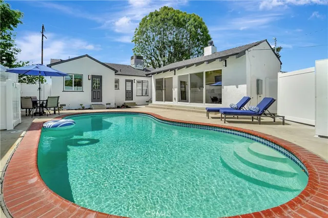 a swimming pool with outdoor seating and yard