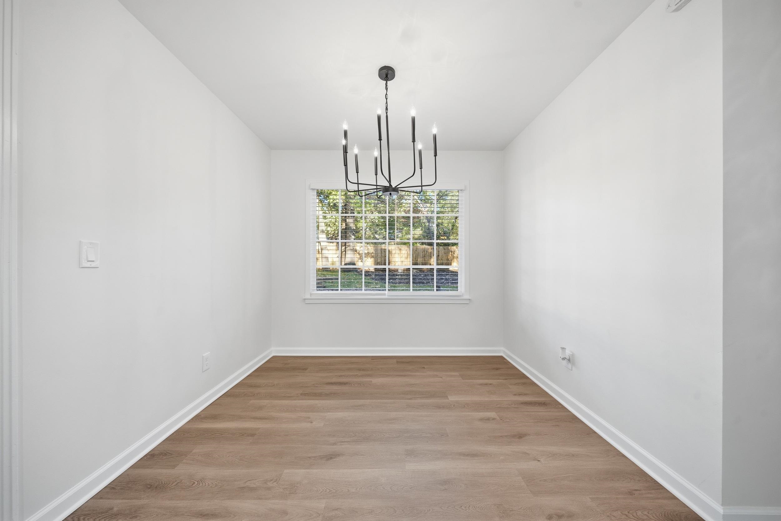 6246 Quince Road Memphis, TN 38119 - Photo 12 of 27 a view of empty room with wooden floor and fan