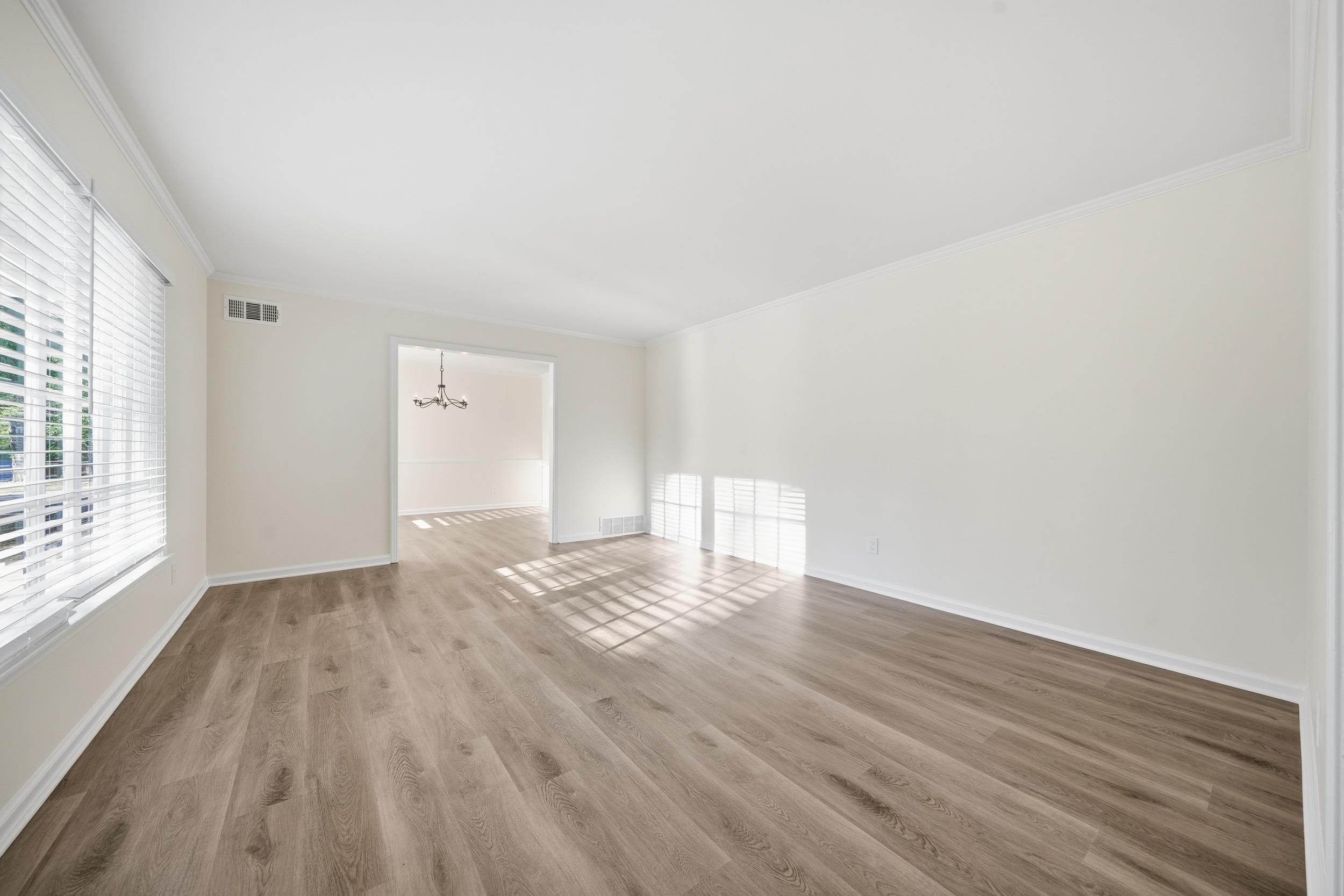 6246 Quince Road Memphis, TN 38119 - Photo 13 of 27 wooden floor in an empty room with a window