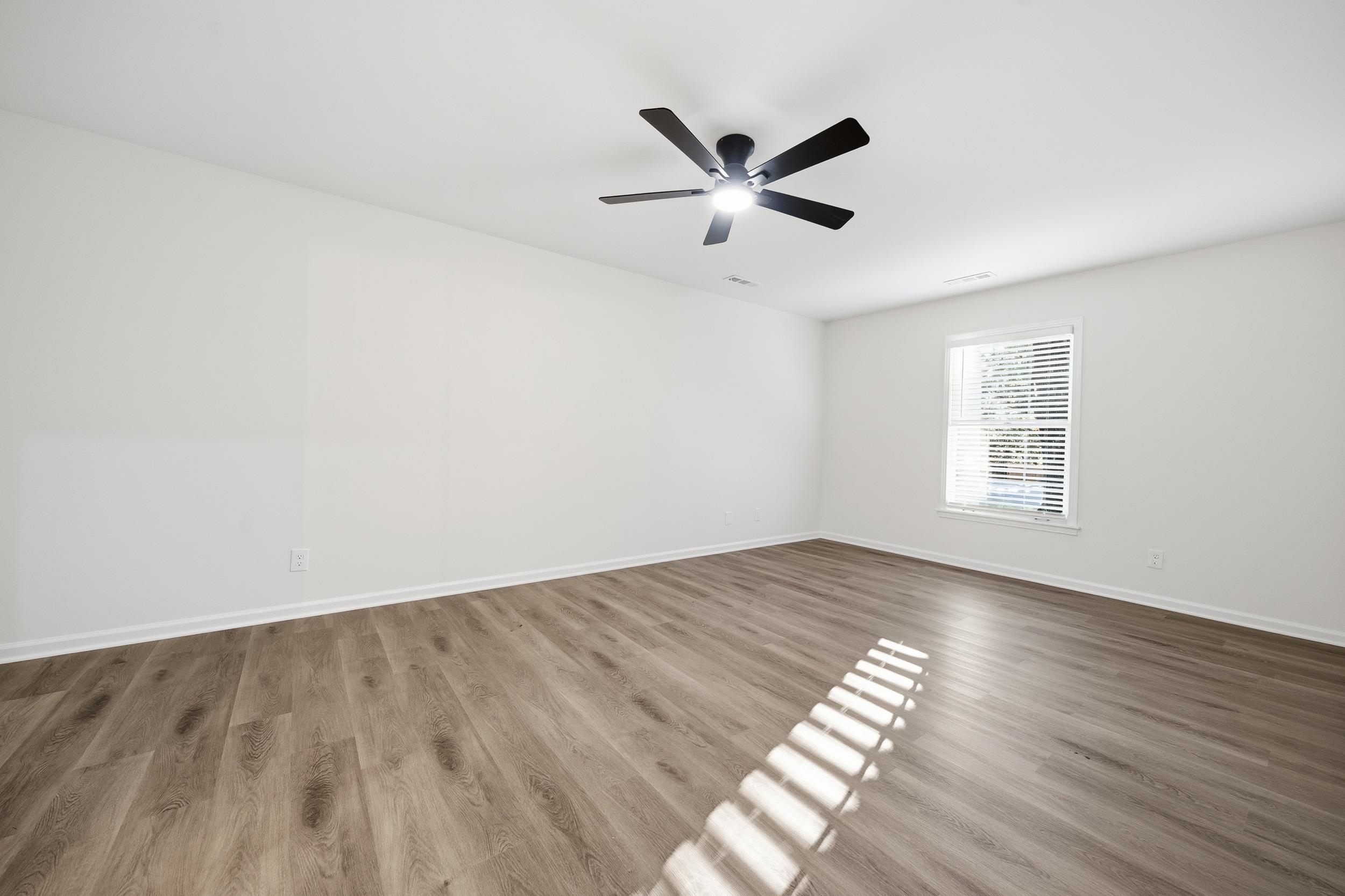 6246 Quince Road Memphis, TN 38119 - Photo 16 of 27 a view of empty room with wooden floor and window