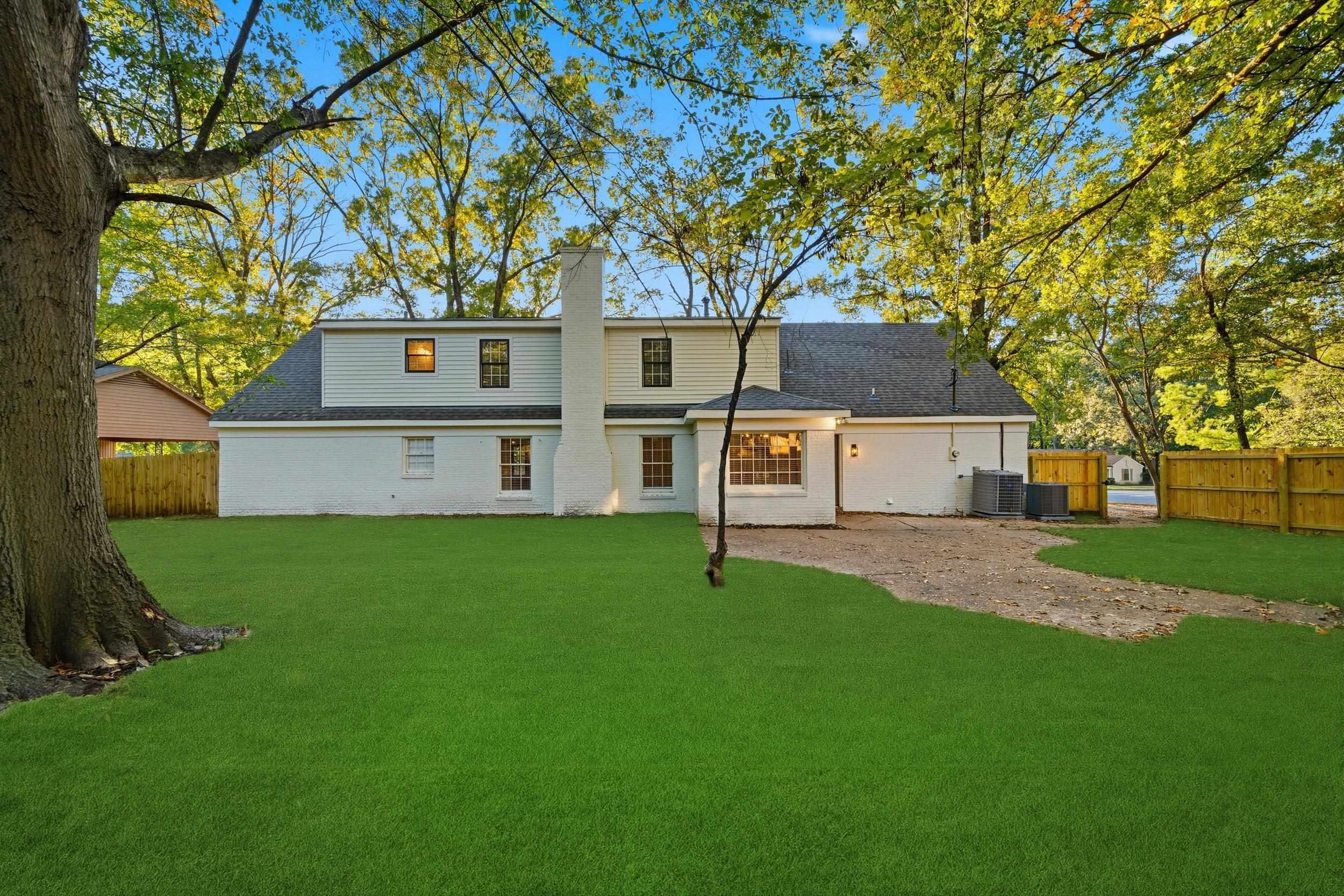 6246 Quince Road Memphis, TN 38119 - Photo 25 of 27 a front view of house with yard and trees in the background