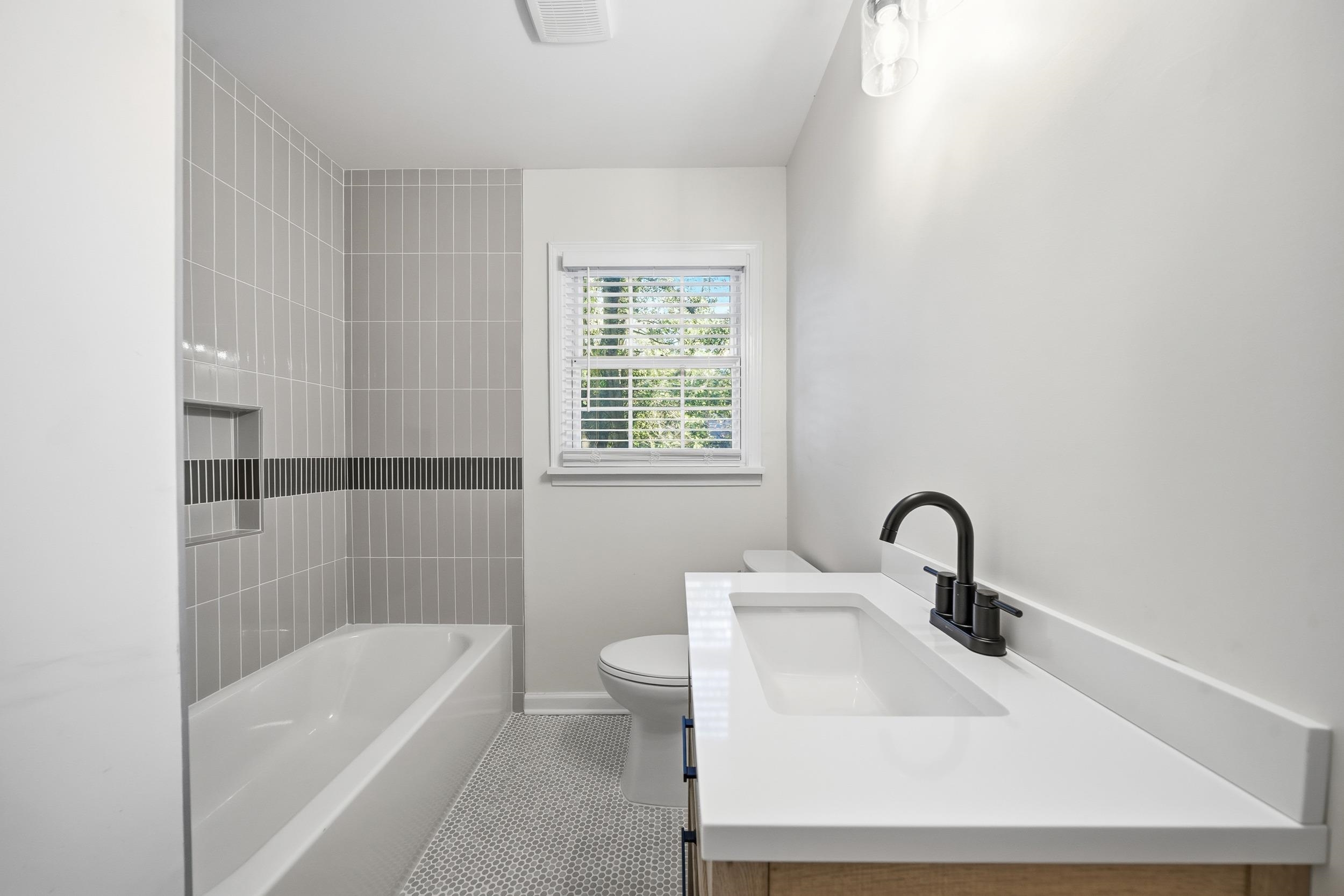 6246 Quince Road Memphis, TN 38119 - Photo 8 of 27 a bathroom with a sink a toilet and bathtub