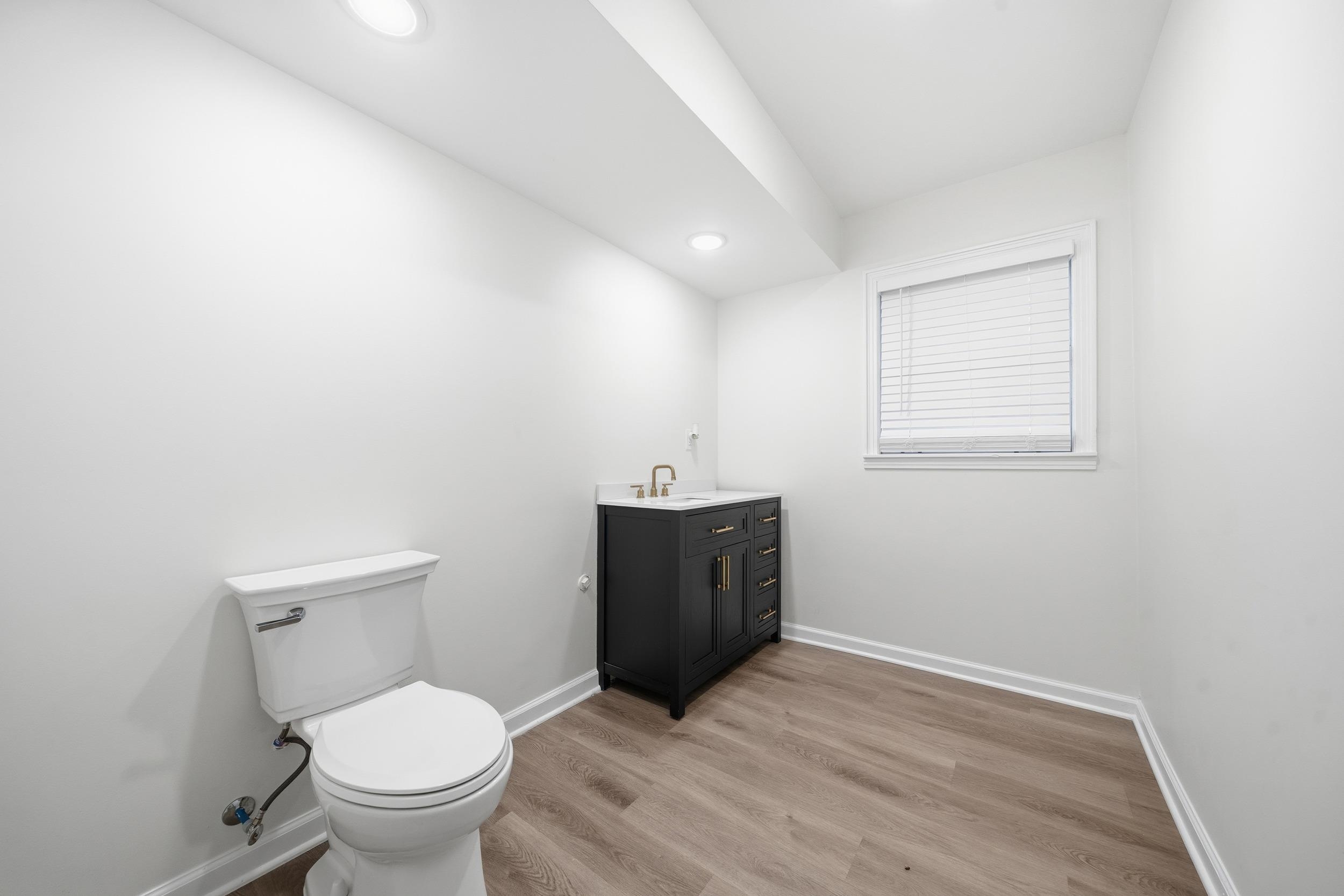 6246 Quince Road Memphis, TN 38119 - Photo 9 of 27 a bathroom with a sink a toilet and a mirror