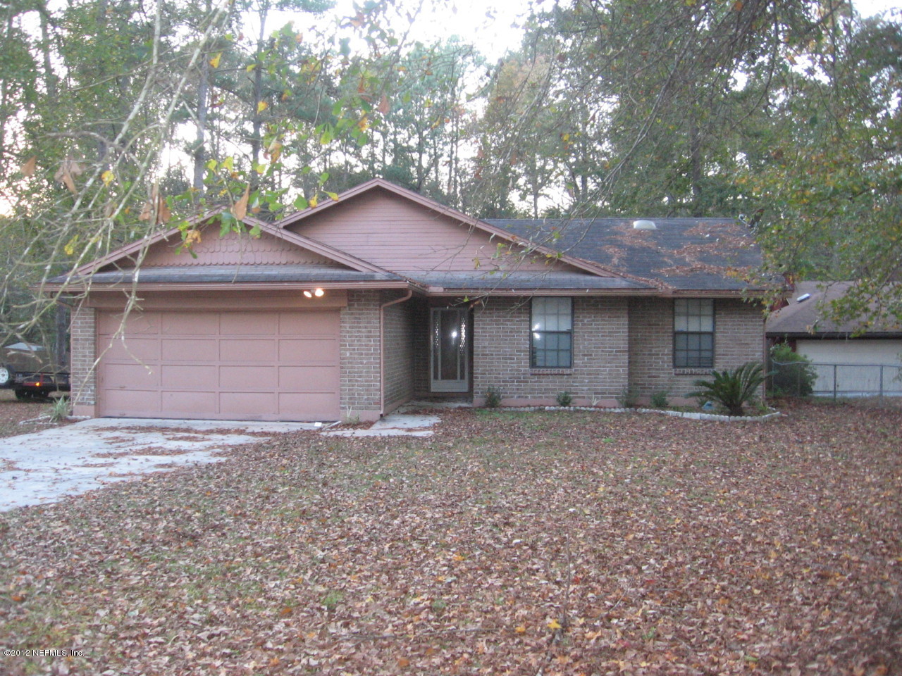 1952 Rothbury Drive Jacksonville, FL 32221 - Photo 1 of 9 a front view of a house with a garden and yard