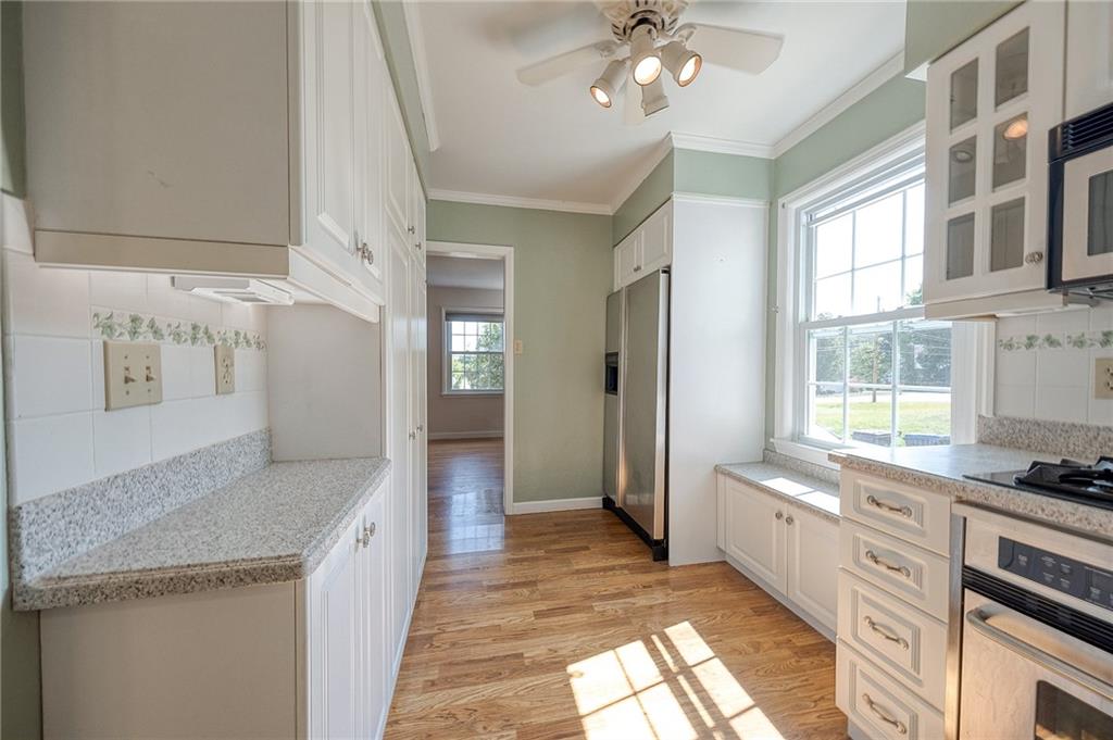 9765 Grosick Road Pittsburgh, PA 15237 - Photo 11 of 33 a large kitchen with stainless steel appliances granite countertop a stove and a sink