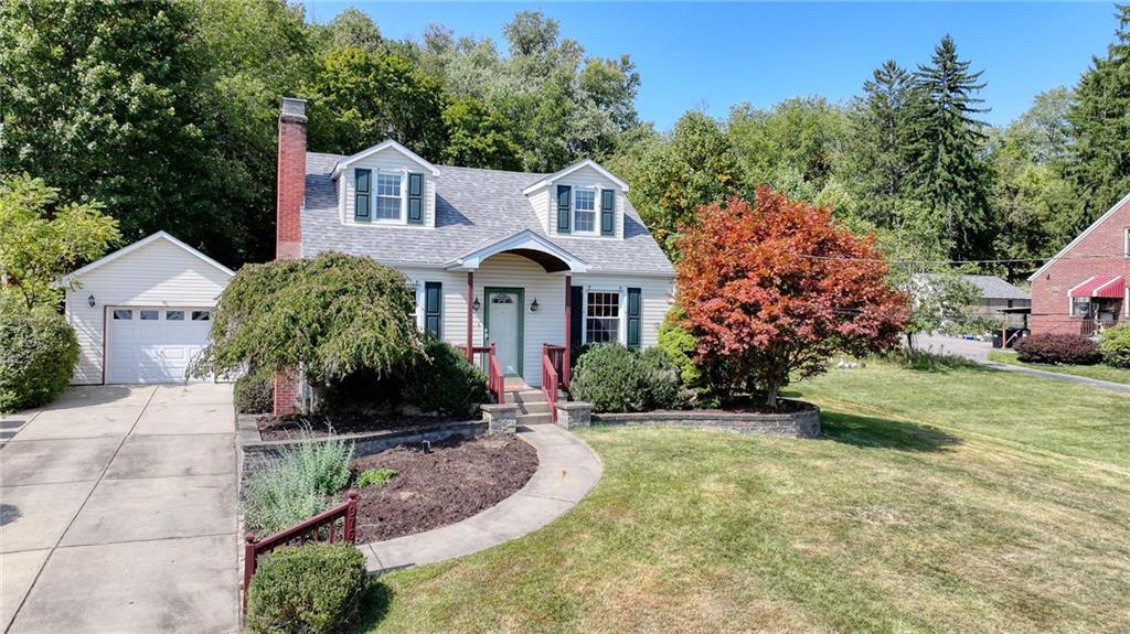 9765 Grosick Road Pittsburgh, PA 15237 - Photo 2 of 33 a front view of a house with garden