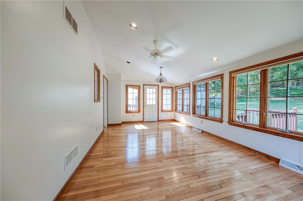 9765 Grosick Road Pittsburgh, PA 15237 - Photo 6 of 33 a view of an empty room with a window and wooden floor