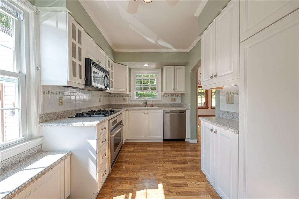 9765 Grosick Road Pittsburgh, PA 15237 - Photo 8 of 33 a kitchen with stainless steel appliances granite countertop a stove a sink and a refrigerator