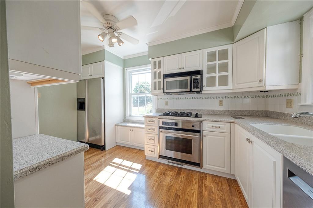 9765 Grosick Road Pittsburgh, PA 15237 - Photo 9 of 33 a kitchen with stainless steel appliances granite countertop a stove a sink and a refrigerator