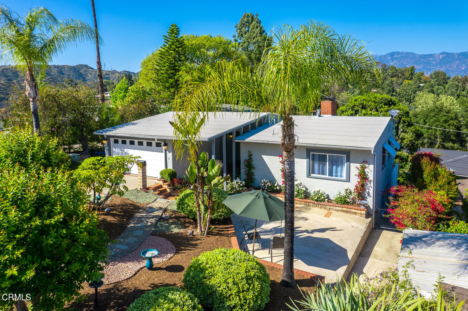 100 Sequoia Drive Pasadena, CA 91105 - Photo 2 of 51 a patio with a table and chairs and potted plants