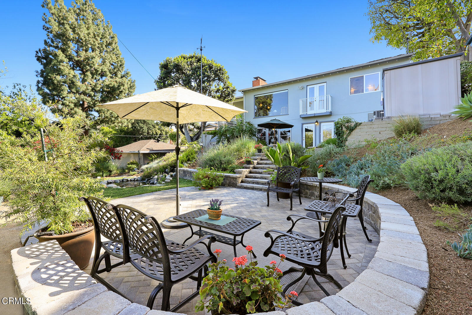 100 Sequoia Drive Pasadena, CA 91105 - Photo 40 of 51 a view of a patio with furniture and table under an umbrella with potted plants