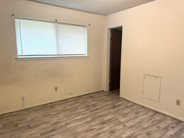 a view of a room with wooden floor