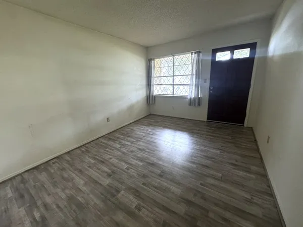a kitchen with stainless steel appliances a refrigerator and wooden floor
