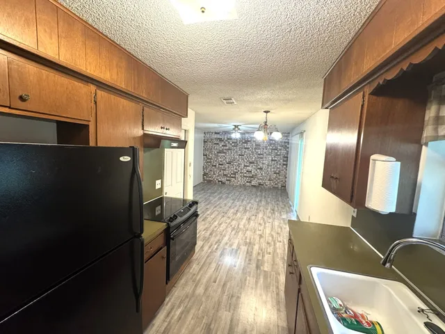 a kitchen with stainless steel appliances a refrigerator and a stove
