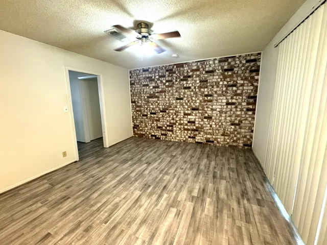 a view of a room with wooden floor