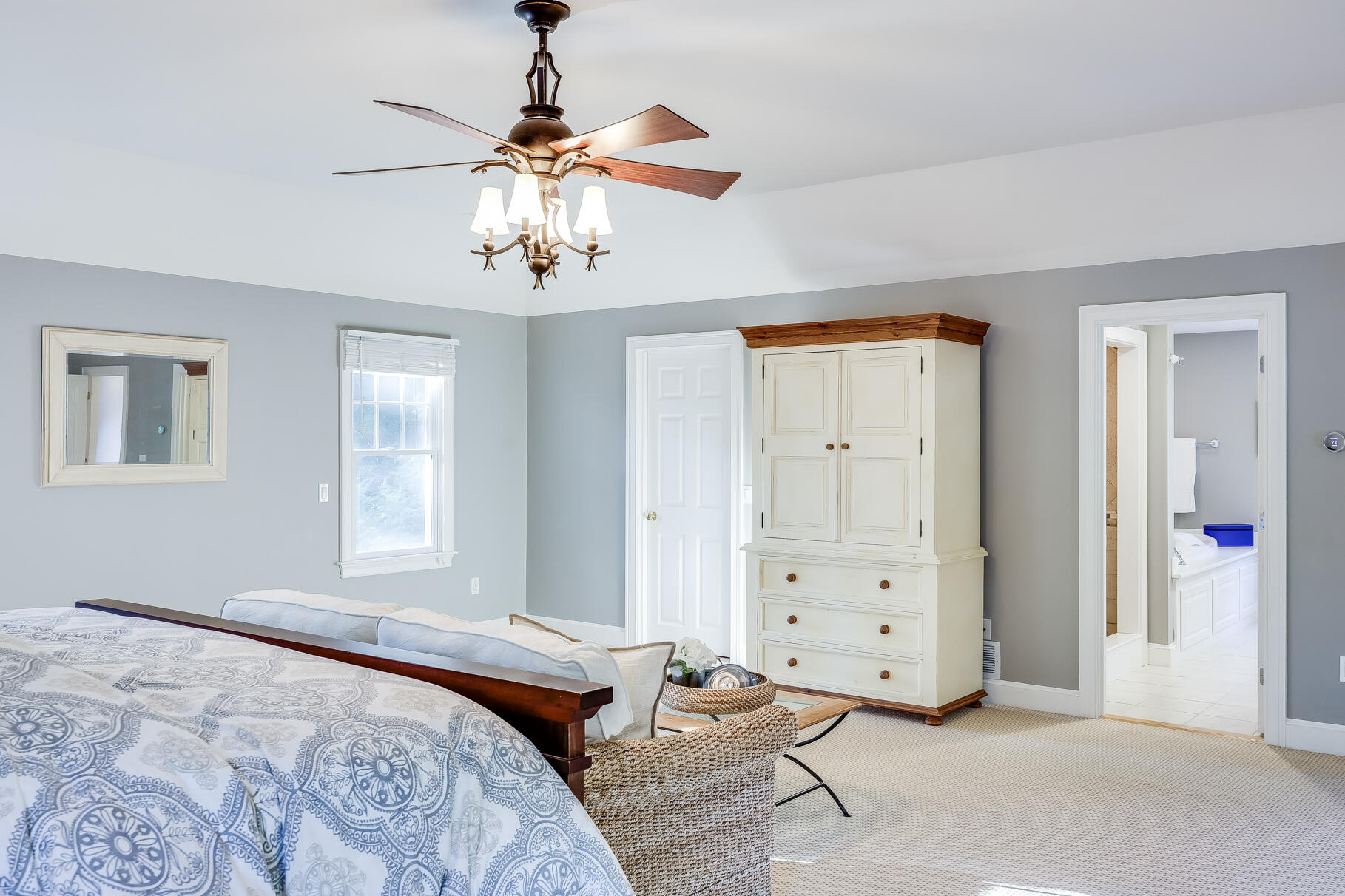 125 Service Road East Sandwich, MA 02537 - Photo 54 of 87 a bedroom with a bed and a chandelier fan