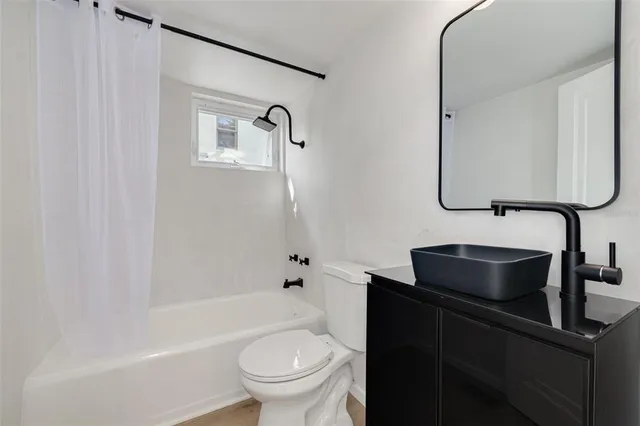 a kitchen with stainless steel appliances a stove microwave and sink