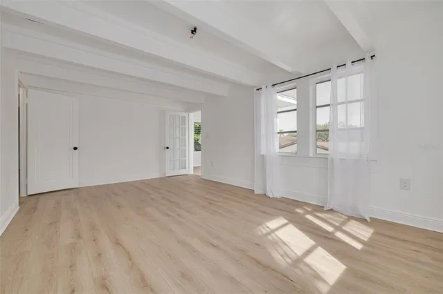 a view of a room that has a white car parked in it