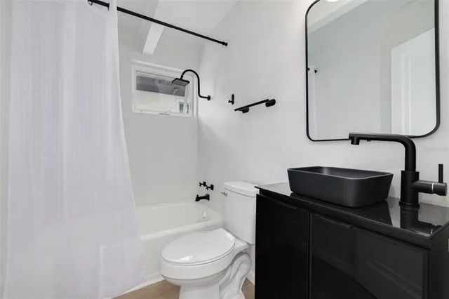 a view of a house with backyard and tree s