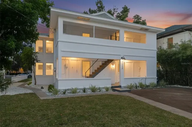 a front view of a house with a garden