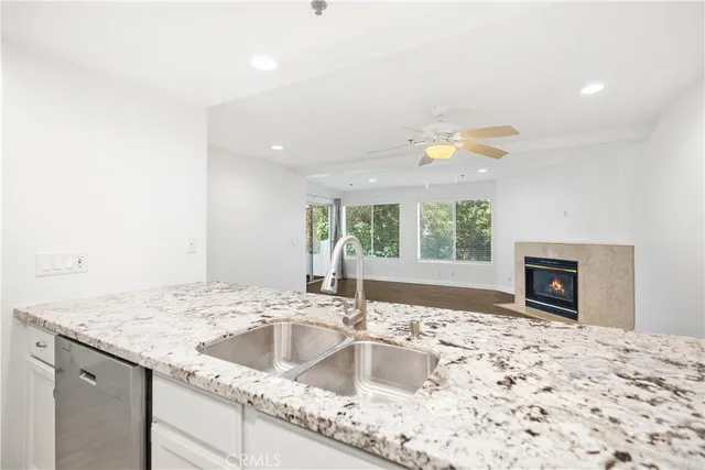 a kitchen with a sink window and cabinets