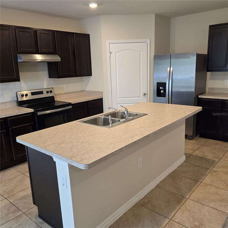 814 Sun Burst Road Winter Haven, FL 33880 - Photo 18 of 48 a kitchen with a sink a stove and refrigerator