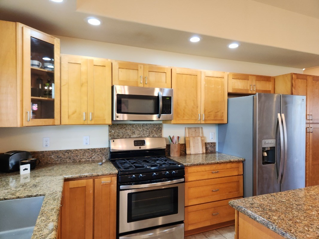1507 Haleloke Street Hilo, HI 96720 - Photo 12 of 21 a kitchen with stainless steel appliances granite countertop a stove a refrigerator and a sink