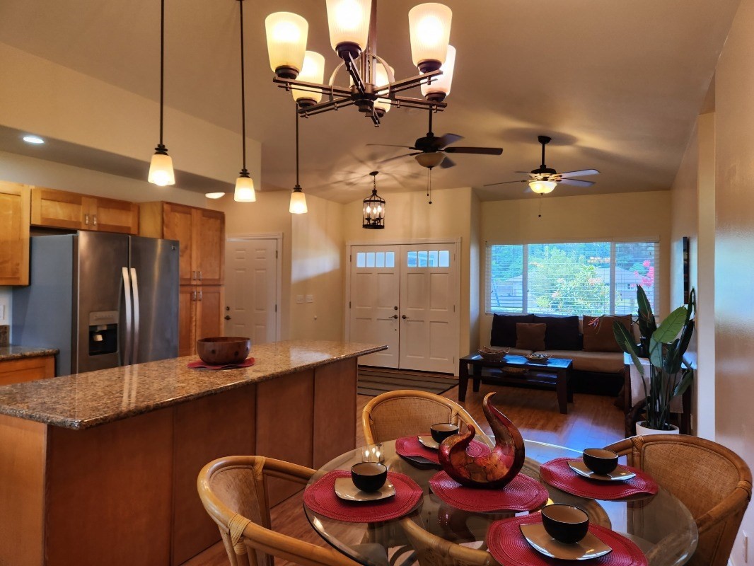 1507 Haleloke Street Hilo, HI 96720 - Photo 13 of 21 a kitchen with a table chairs stove and cabinets