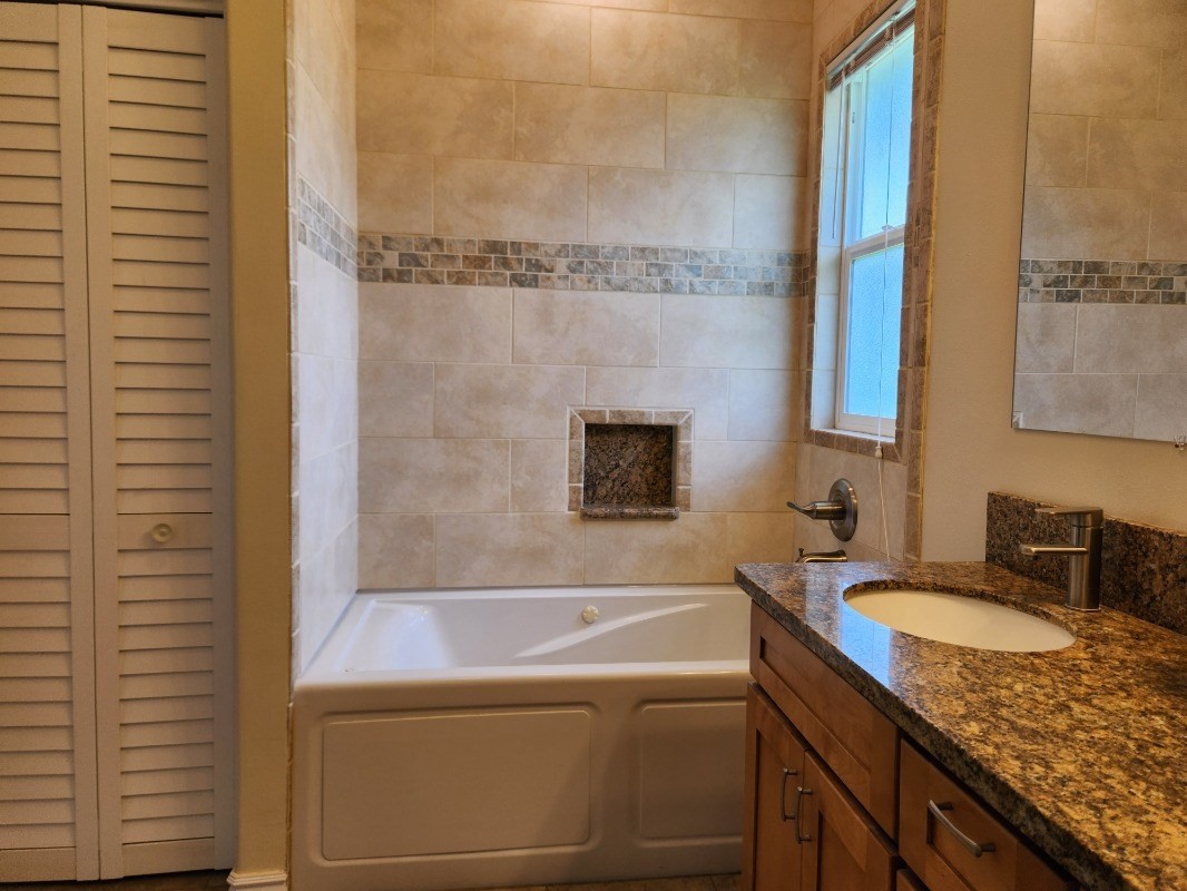1507 Haleloke Street Hilo, HI 96720 - Photo 17 of 21 a bathroom with a granite countertop bathtub sink vanity and toilet