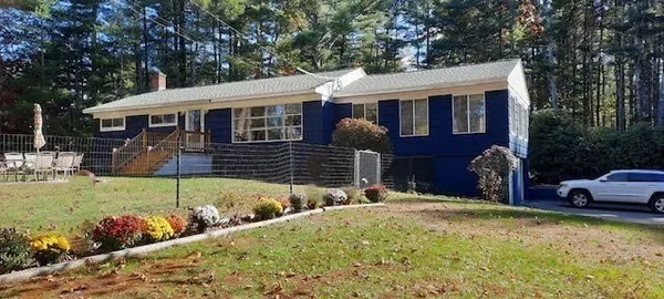 a front view of house with a garden