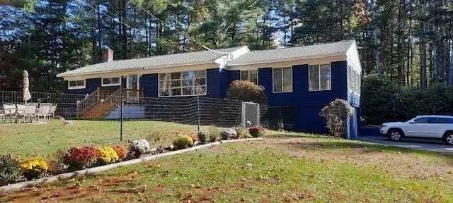 a front view of house with a garden