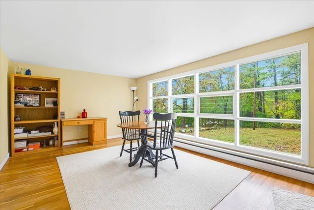 a view of a workspace with furniture and a window