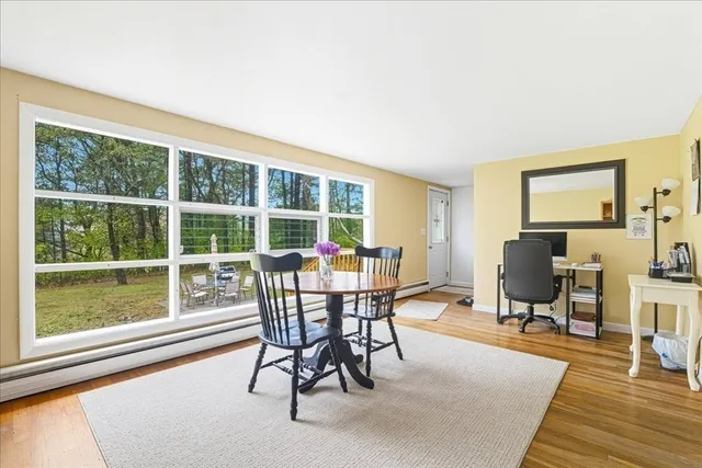 a dining room with furniture and wooden floor
