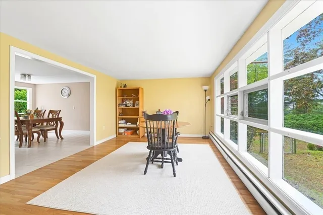 a living room with furniture and a table with wooden floor