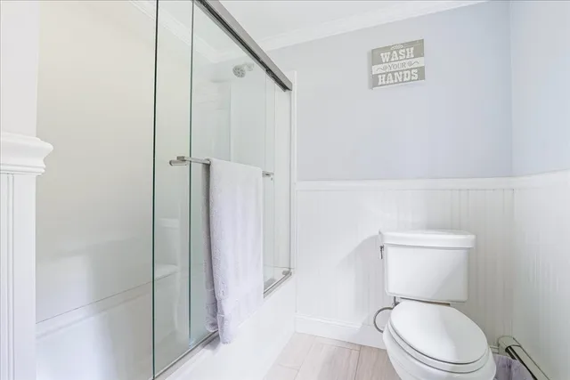 a white toilet sitting next to a bathroom sink
