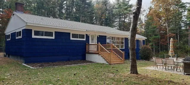 a front view of a house with a garden
