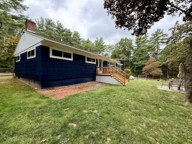 a view of house with backyard