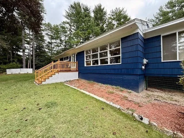 a view of house with backyard