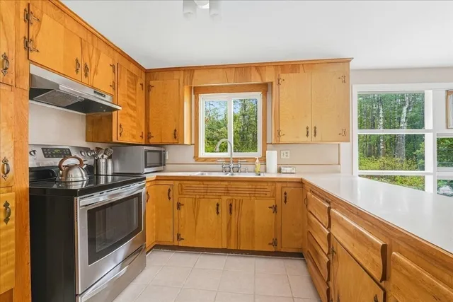 a kitchen with stainless steel appliances granite countertop a stove and a sink