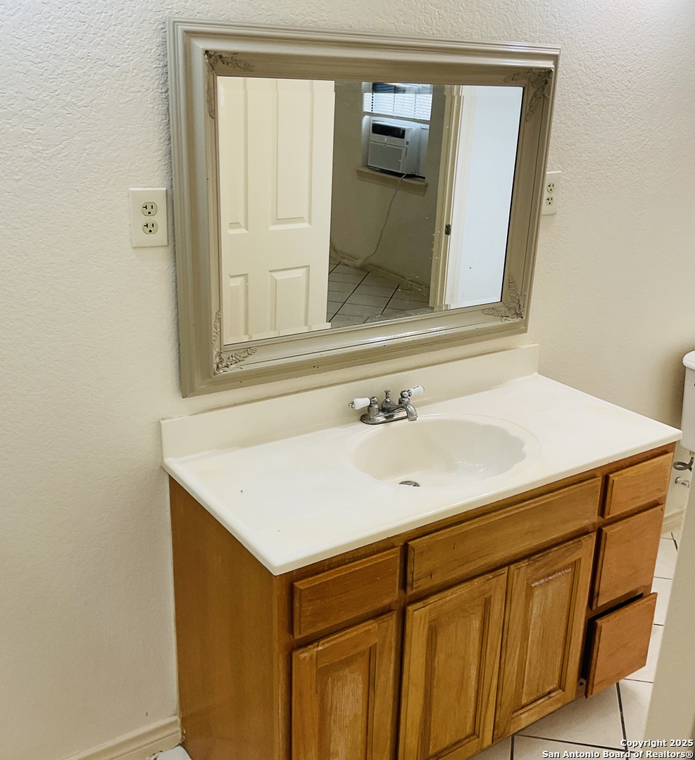 517 West Barnard Sabinal, TX 78881 - Photo 8 of 17 a bathroom with a sink and a mirror
